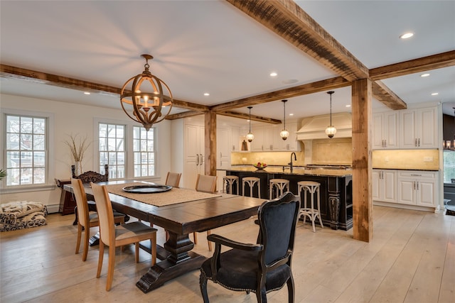 dining area featuring beamed ceiling, light wood finished floors, a chandelier, and recessed lighting