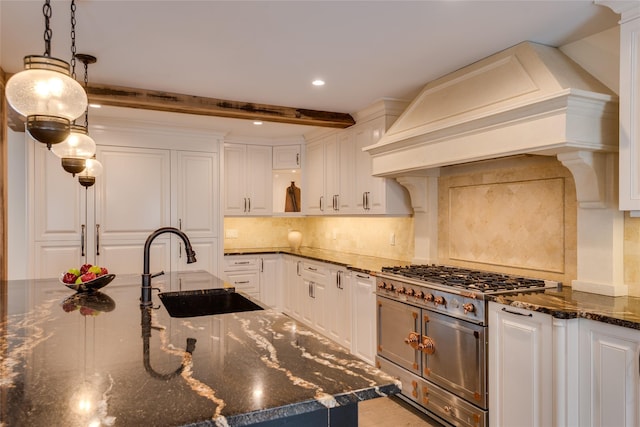 kitchen featuring premium range hood, a sink, white cabinetry, beamed ceiling, and decorative backsplash