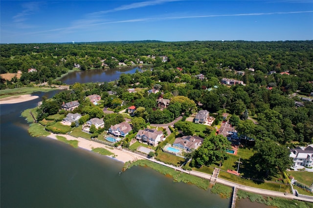 birds eye view of property featuring a water view and a forest view