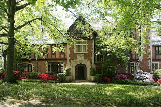 english style home with brick siding