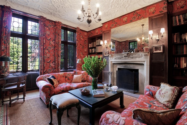 living area with wallpapered walls, a fireplace with flush hearth, and an inviting chandelier