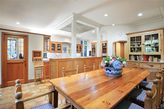 dining room with arched walkways, crown molding, and recessed lighting