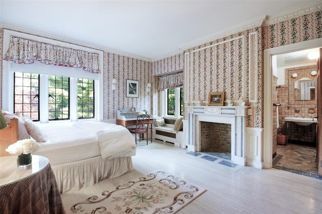 bedroom featuring ornamental molding, a fireplace with flush hearth, and wallpapered walls