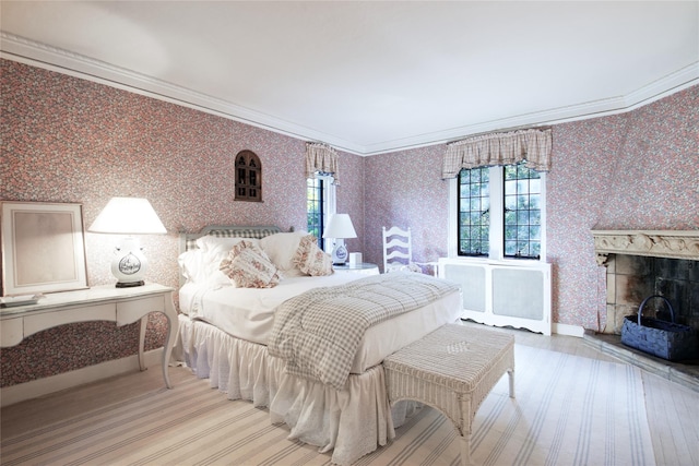 bedroom with crown molding, multiple windows, and wallpapered walls