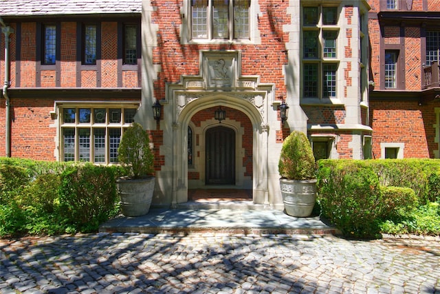 property entrance featuring brick siding