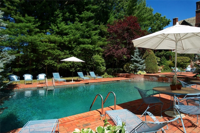 outdoor pool with a patio area