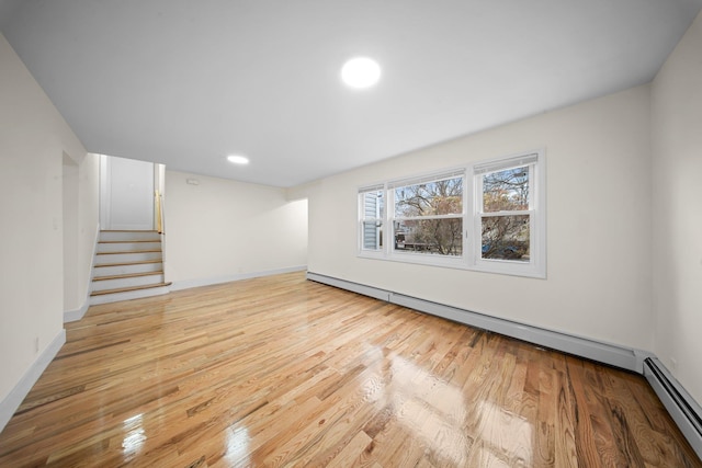 below grade area featuring stairway, recessed lighting, wood finished floors, and baseboards