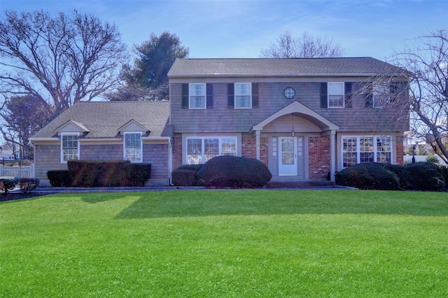 colonial house with roof with shingles and a front lawn