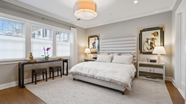 bedroom with baseboards, recessed lighting, wood finished floors, and crown molding