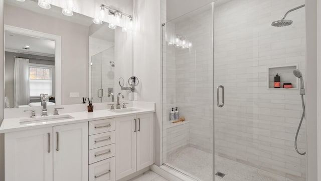 bathroom featuring double vanity, a shower stall, and a sink