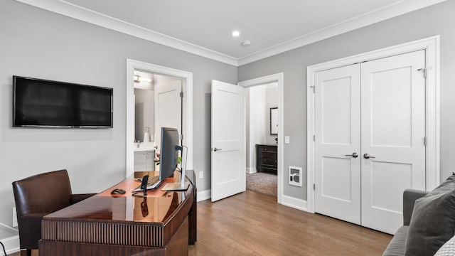 home office featuring baseboards, ornamental molding, wood finished floors, and recessed lighting