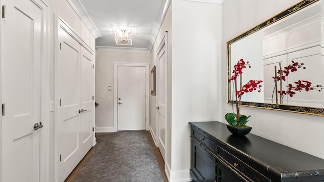 doorway to outside featuring baseboards and crown molding