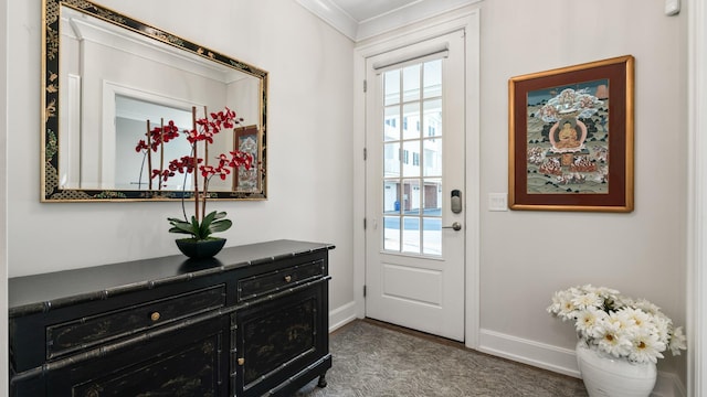 doorway featuring ornamental molding and baseboards