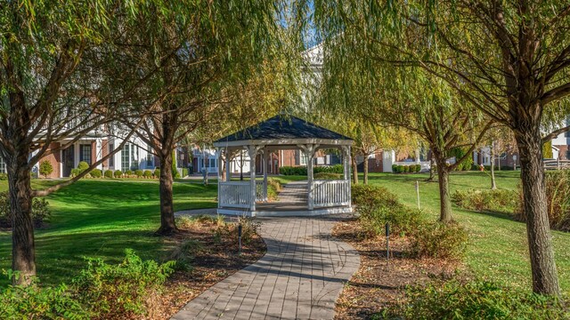 view of community featuring a residential view, a lawn, and a gazebo