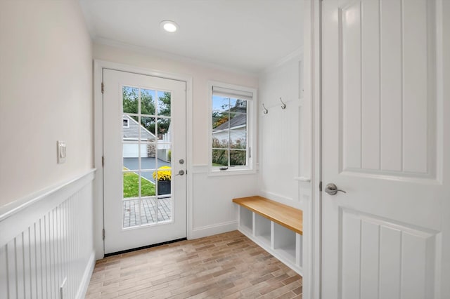 mudroom featuring brick floor, crown molding, recessed lighting, a decorative wall, and wainscoting