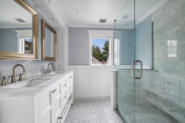 bathroom featuring visible vents, a sink, and ornamental molding