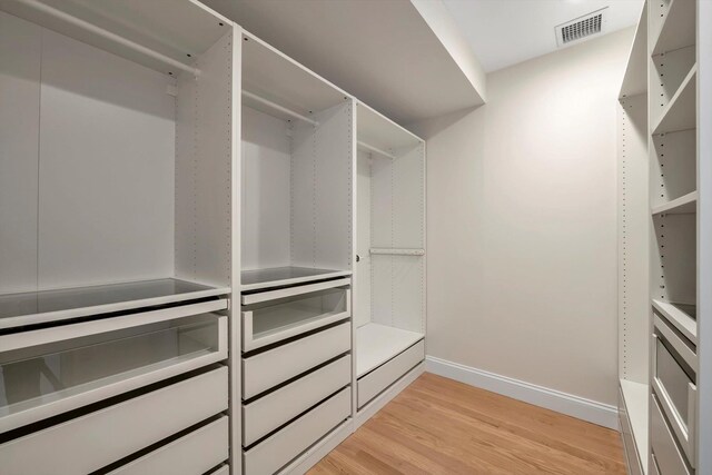 spacious closet featuring light wood-style floors and visible vents