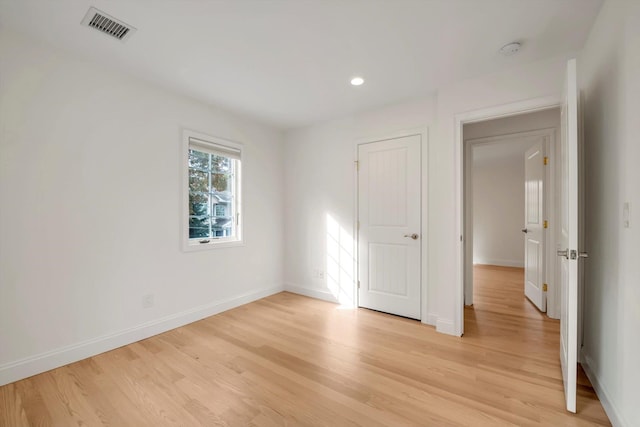 spare room with light wood-style flooring, visible vents, baseboards, and recessed lighting