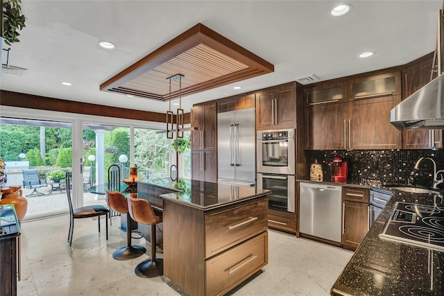 kitchen featuring tasteful backsplash, dark stone counters, glass insert cabinets, appliances with stainless steel finishes, and a sink