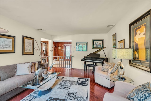 living area featuring wood finished floors and visible vents