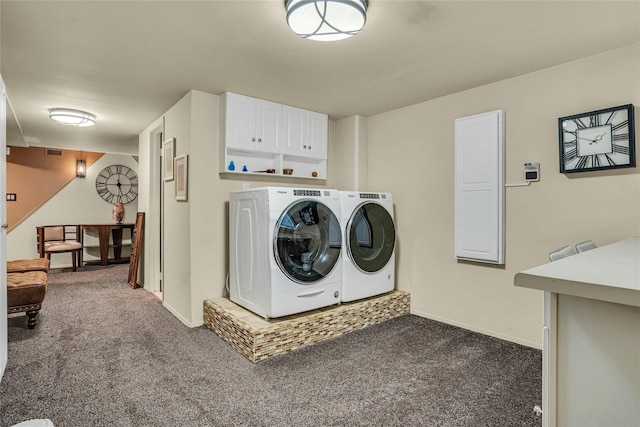 laundry area featuring dark colored carpet, washer and clothes dryer, cabinet space, and baseboards