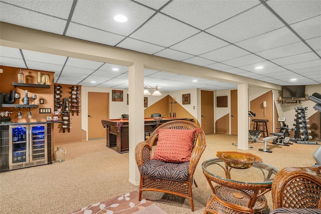 interior space featuring recessed lighting, carpet flooring, a bar, beverage cooler, and a drop ceiling