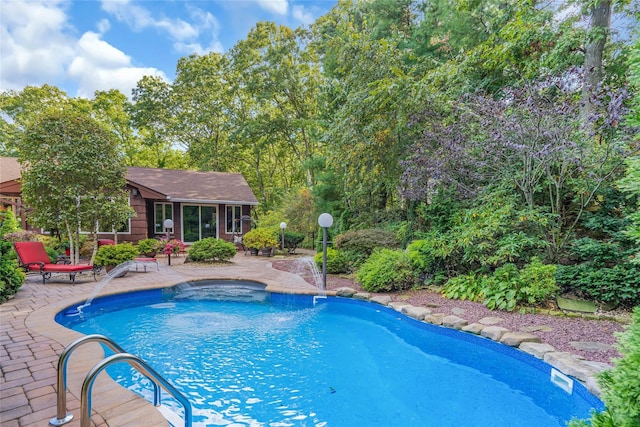 outdoor pool with a patio area