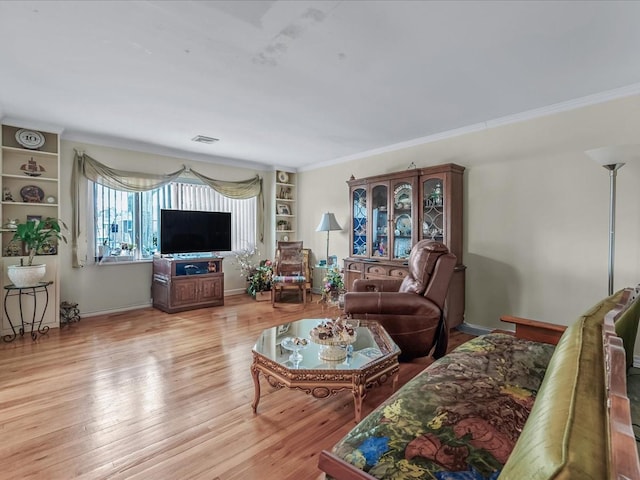 living room with baseboards, light wood-style flooring, and ornamental molding