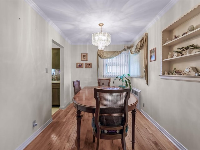 dining room with light wood-style flooring, crown molding, and baseboards