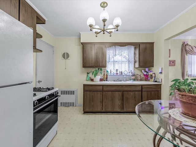 kitchen with white appliances, visible vents, a sink, light countertops, and crown molding