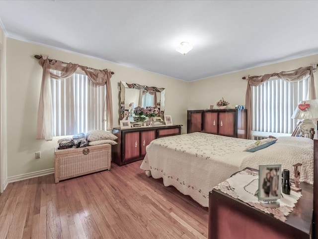 bedroom with baseboards and hardwood / wood-style flooring