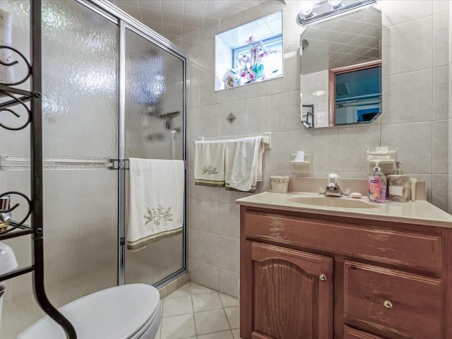 bathroom featuring a shower stall, tile walls, and vanity