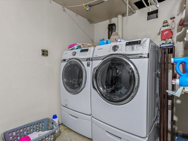 clothes washing area featuring independent washer and dryer and laundry area