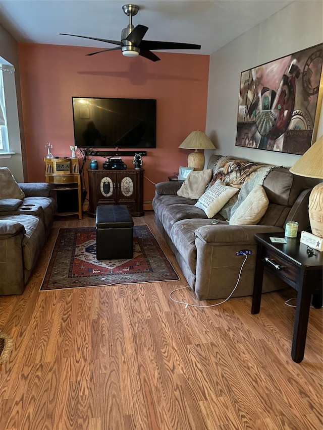 living area featuring ceiling fan and wood finished floors