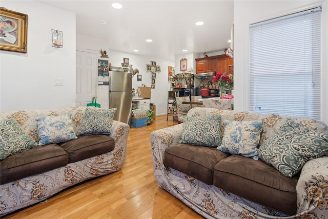 living area with recessed lighting and light wood-style floors