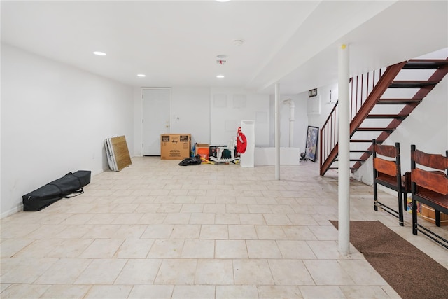 finished basement with stairway and recessed lighting