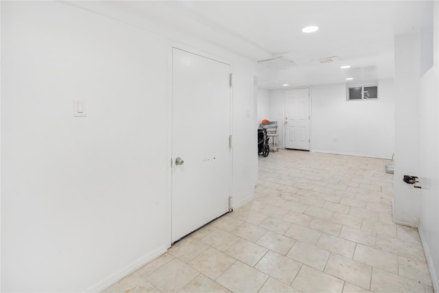 interior space featuring recessed lighting and baseboards
