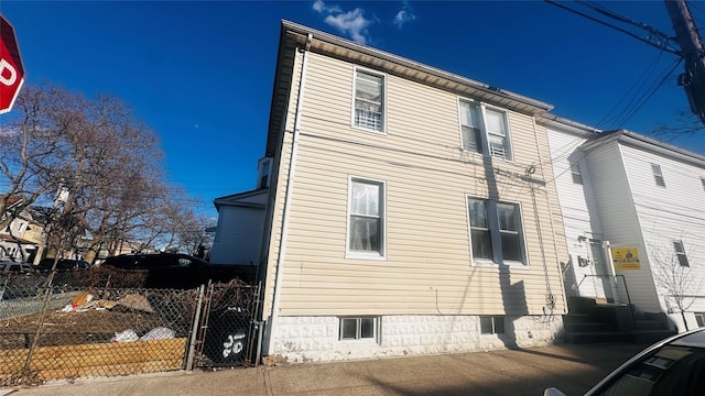 view of property exterior with fence