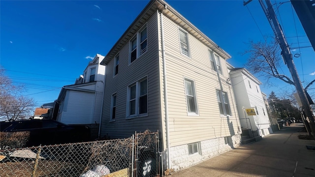 view of property exterior featuring fence