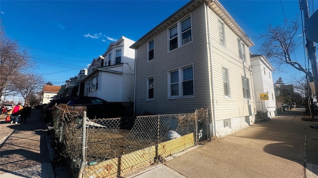 view of side of property featuring fence