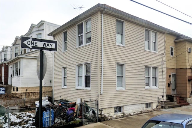 view of side of home with fence