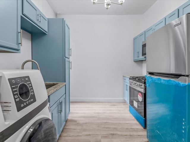 kitchen with light stone counters, blue cabinets, stainless steel appliances, baseboards, and light wood-style floors