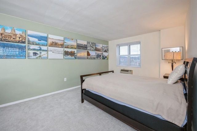 carpeted bedroom featuring baseboards and a wall mounted AC