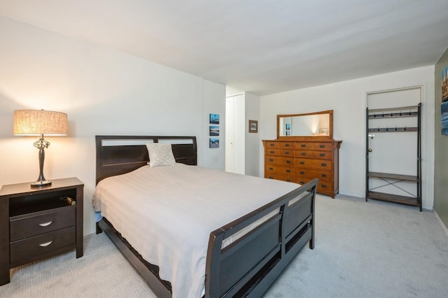 bedroom featuring a closet and light carpet