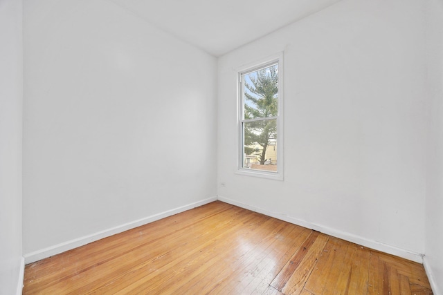 spare room featuring light wood-style flooring and baseboards