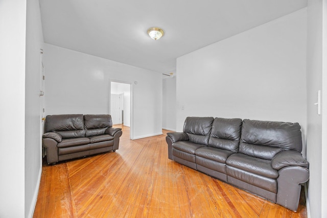 living area featuring baseboards and light wood-style floors