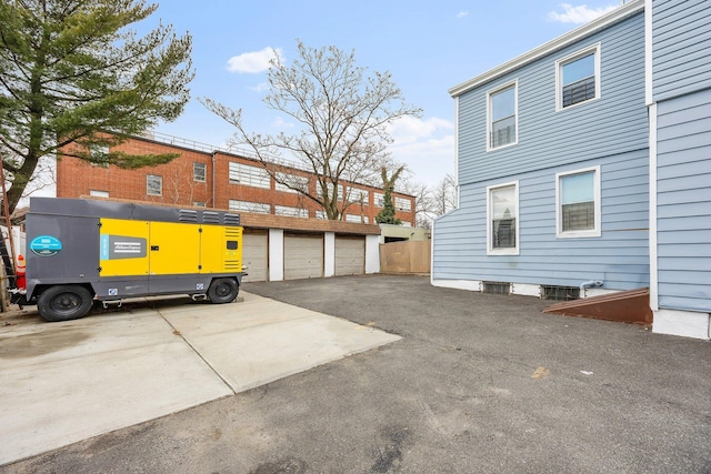 view of side of home with community garages