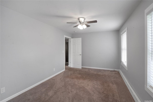 unfurnished room featuring carpet, ceiling fan, and baseboards