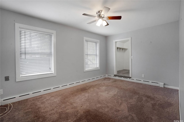 carpeted spare room with a ceiling fan