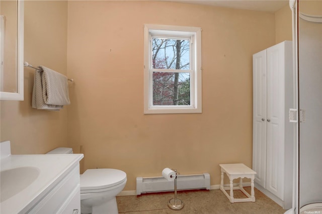 half bath featuring toilet, baseboards, a baseboard heating unit, and vanity